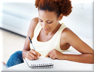 Woman writing on a pad of paper and making a few notes about her recovery