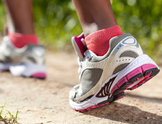 a woman's shoes and lower legs while walking