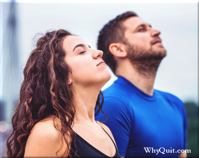 A man and woman taking deep breaths